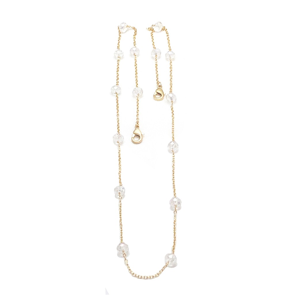 A delicate gold necklace with small pearls and a heart pendant.