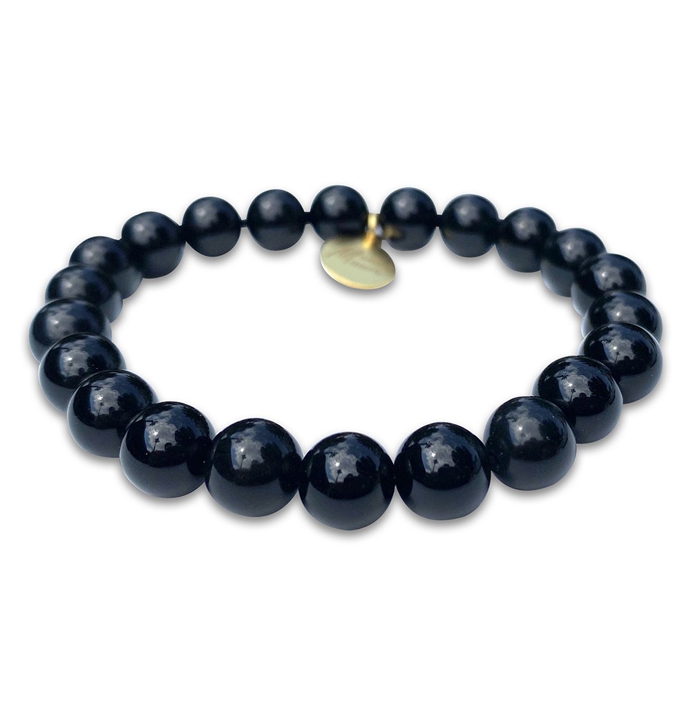 Black beaded bracelet with a single gold bead and charm.