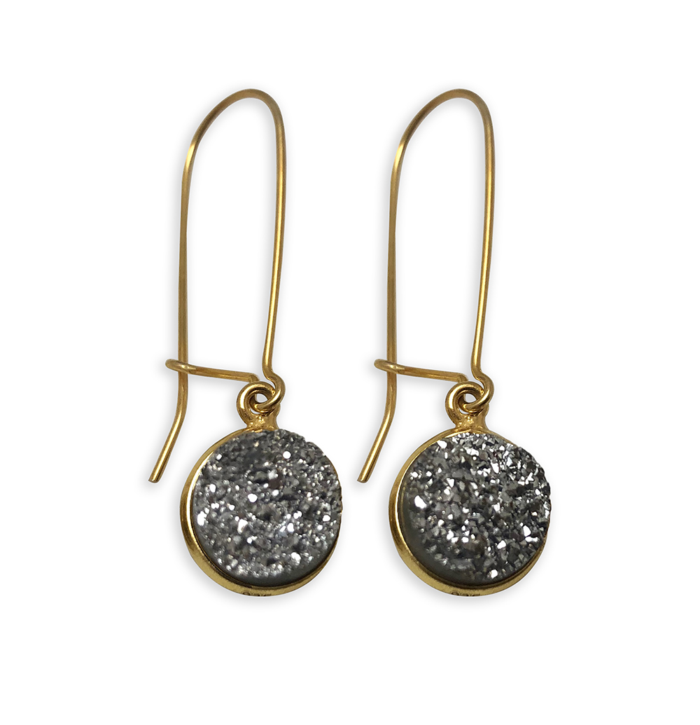 Gold earrings with round, textured black stones.