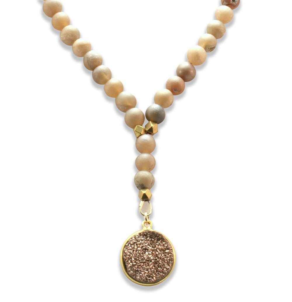 A beaded necklace with a round pendant.