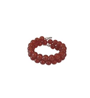 A red beaded bracelet with a silver charm.