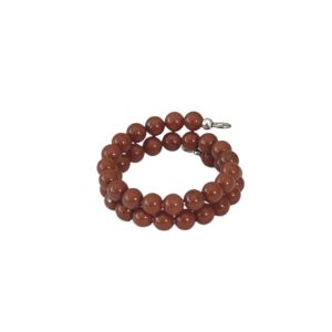 A coiled bracelet made of round brown beads.