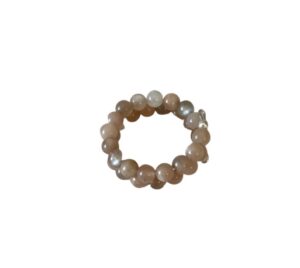 A circular bracelet made of round, beige stones.