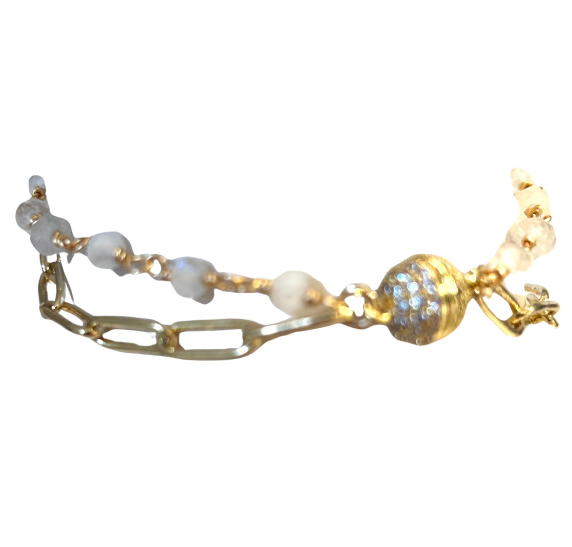 A delicate bracelet with pearls and a golden charm.