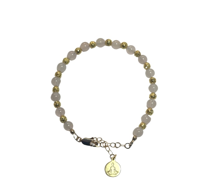 A beaded bracelet with a round charm pendant.