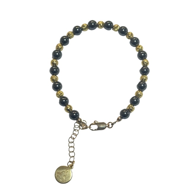 A beaded bracelet with blue and gold beads and a small round charm.