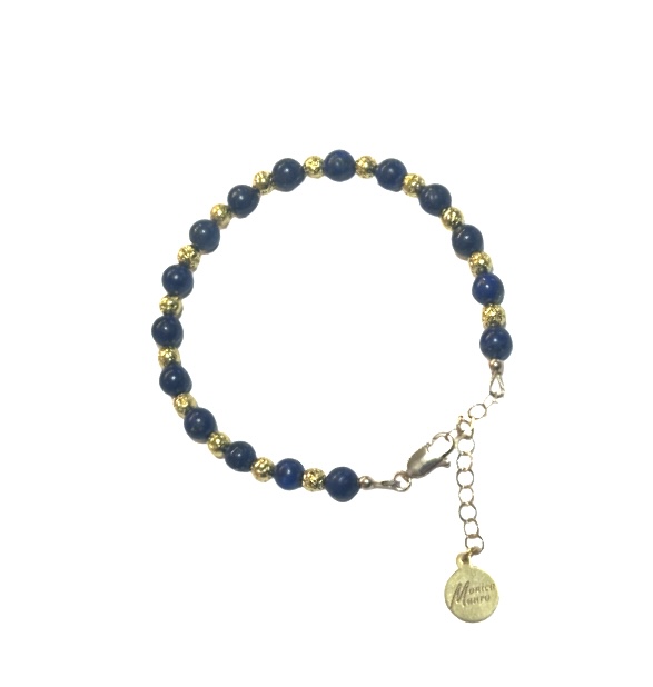 A beaded bracelet with blue stones and a gold charm.
