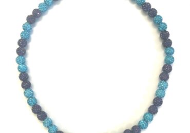 Blue and black beaded necklace on display.